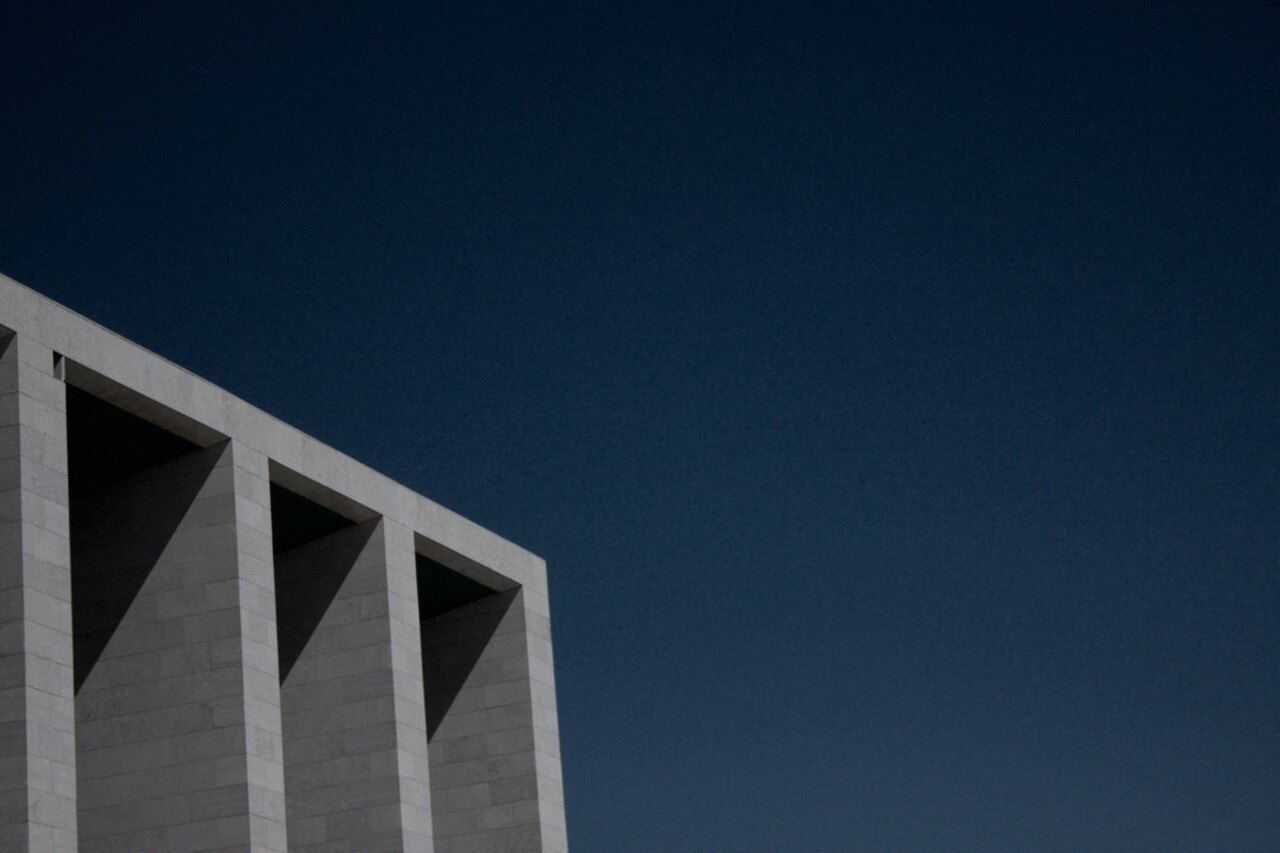 Concrete architecture against a deep sky